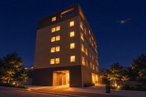 夜空の下で窓と入口に明かりがともるEZ HOTEL 関西空港 Seasideの外観を描いたイラスト
